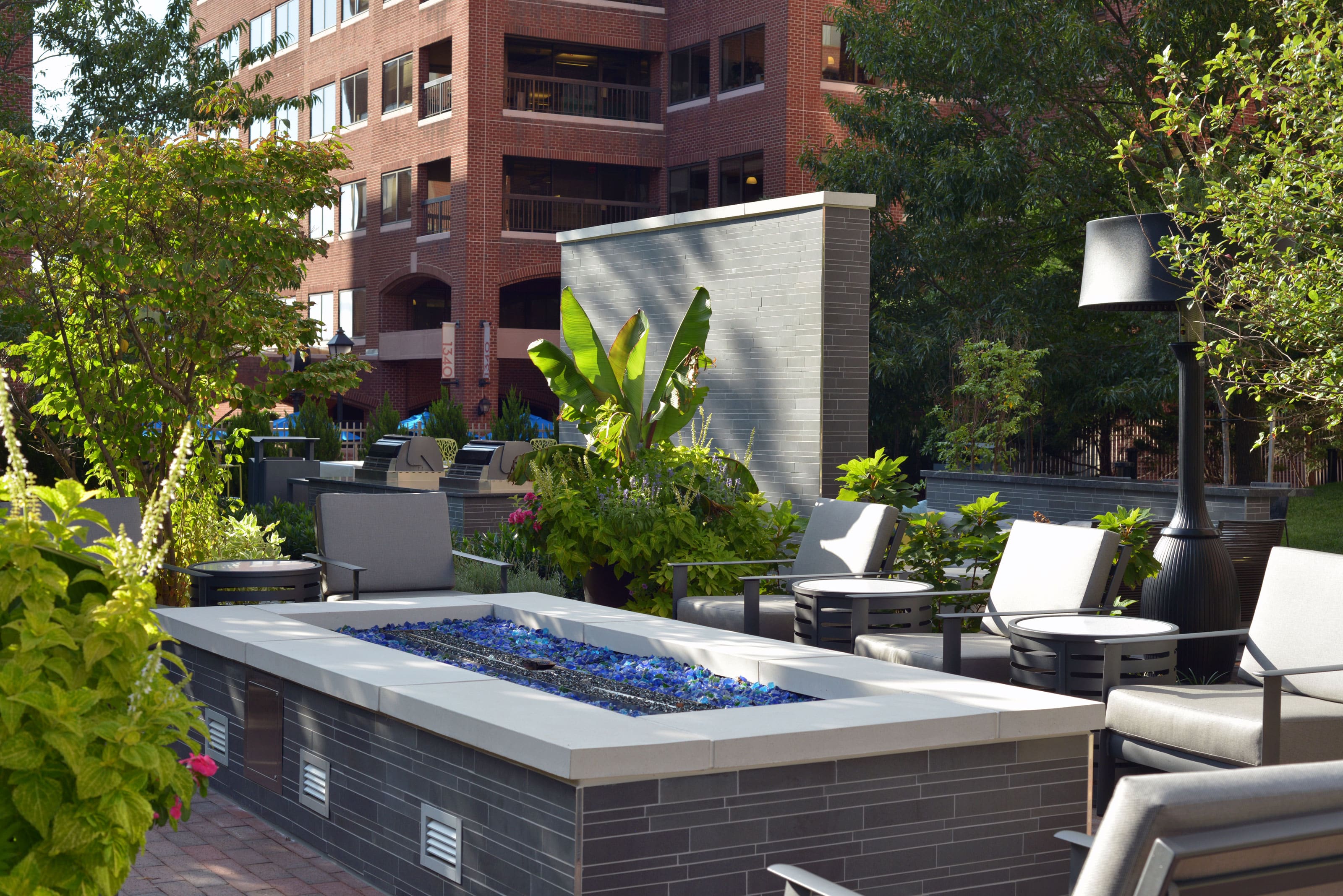 Norstone Grey Basalt Interlocking Tiles used on a large rectangular fire pit